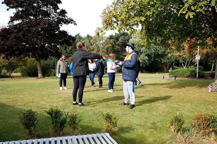 A group of learners standing in a park