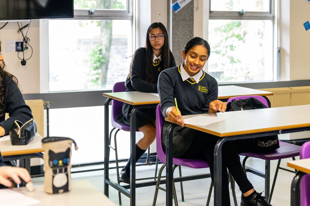 Image of two female pupils at their school desks