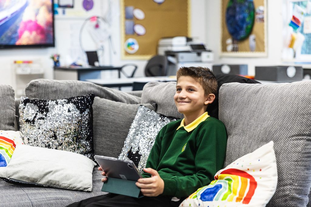 Young boy reading on his ipad