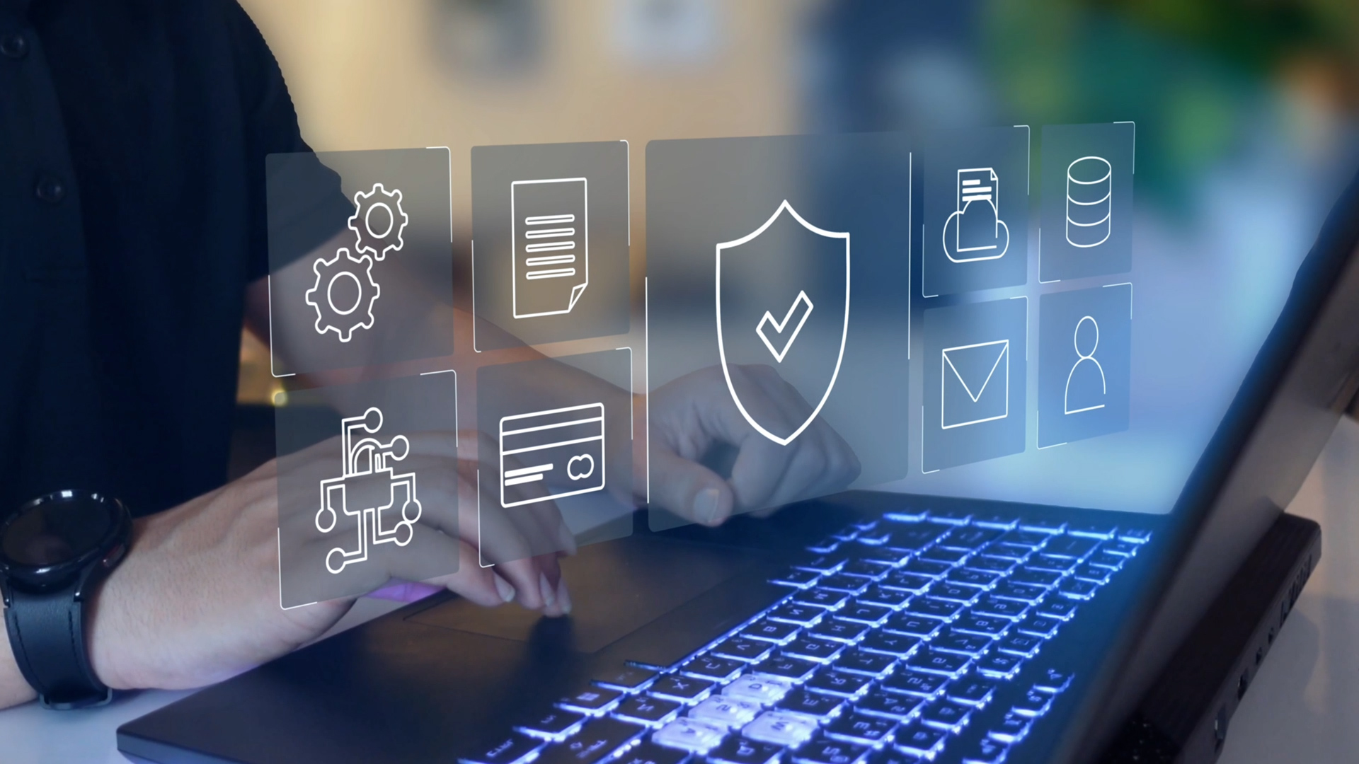 Person typing on a laptop keyboard with glowing keys while translucent digital icons appear above the device, including a shield with a tick, a database, a document, gears, a credit card, a network chip, a message envelope, and a user profile, representing cybersecurity, data protection, and digital systems.
