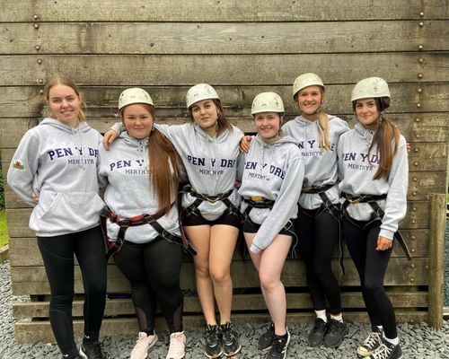 Young people wearing "Pen Y Dre" hoodies and safety gear